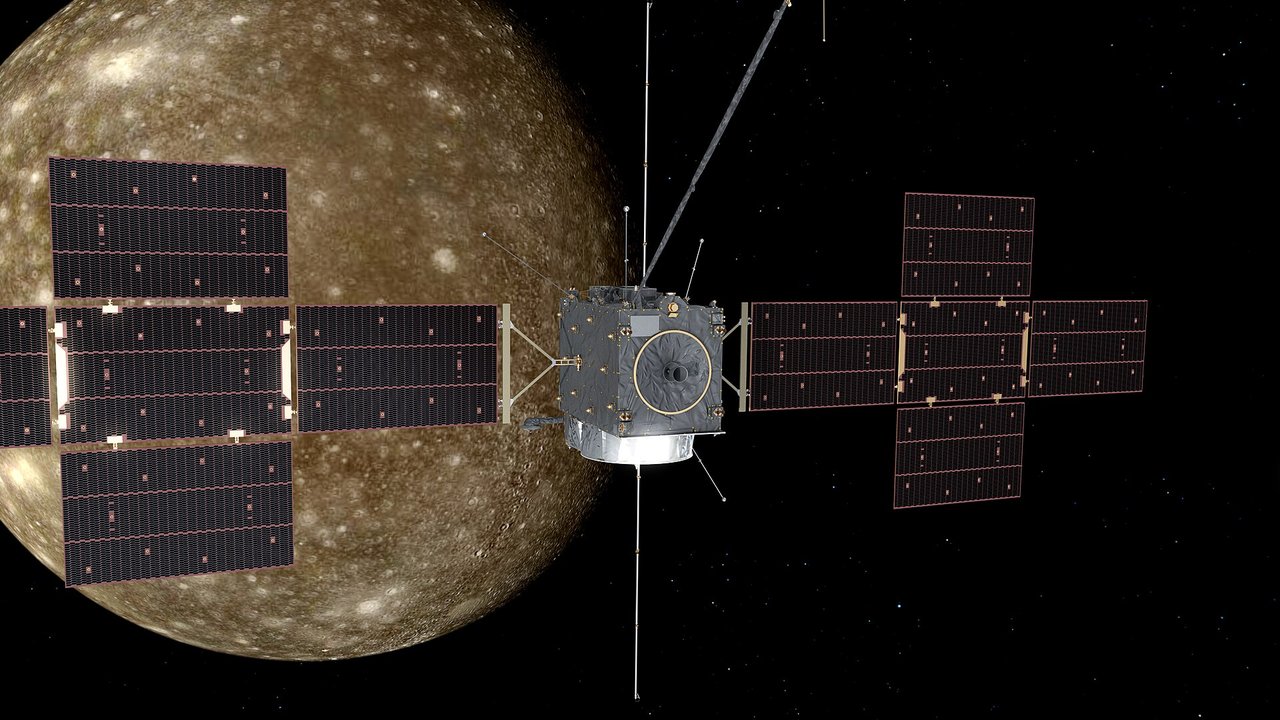 Artist’s concept of JUICE flying past an icy moon with its large solar arrays extended
